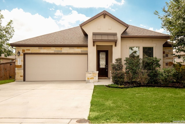 view of front of house featuring a front yard and a garage