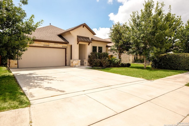 view of front of home with a garage and a front lawn