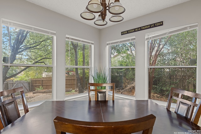 dining room featuring a notable chandelier and a textured ceiling