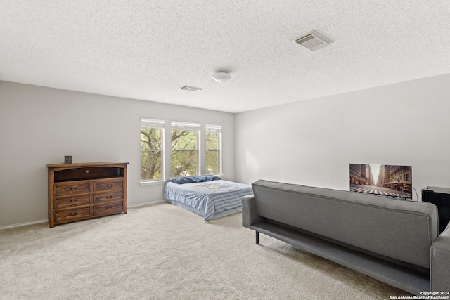 carpeted bedroom featuring a textured ceiling