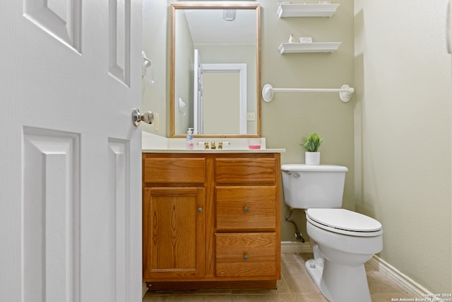 bathroom featuring vanity, toilet, and tile patterned floors