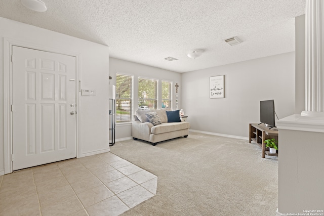 carpeted living room with a textured ceiling