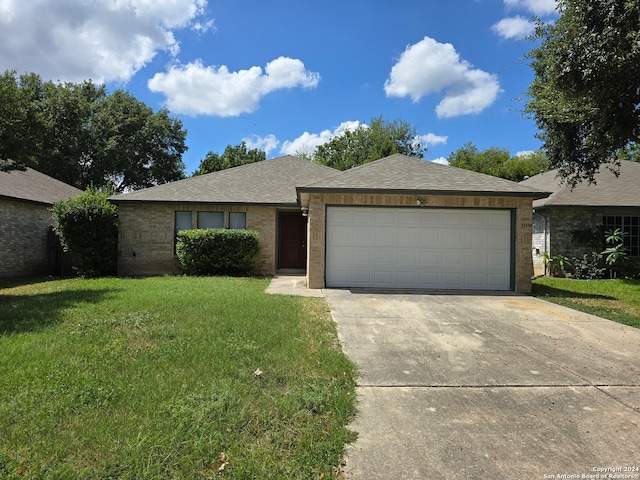 ranch-style home with a front yard and a garage