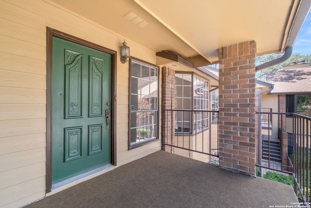 view of exterior entry with covered porch