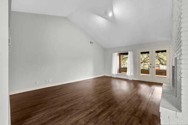 unfurnished living room featuring high vaulted ceiling, wood-type flooring, a textured ceiling, and french doors