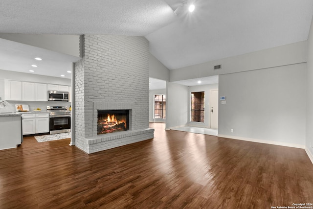 unfurnished living room featuring a textured ceiling, a fireplace, dark wood-type flooring, and high vaulted ceiling