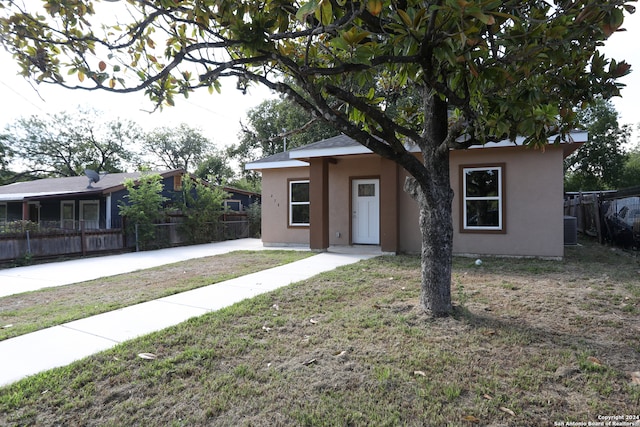 view of front of home featuring central AC and a front yard