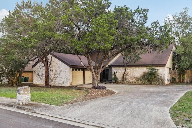 view of front of property featuring a front yard and a garage