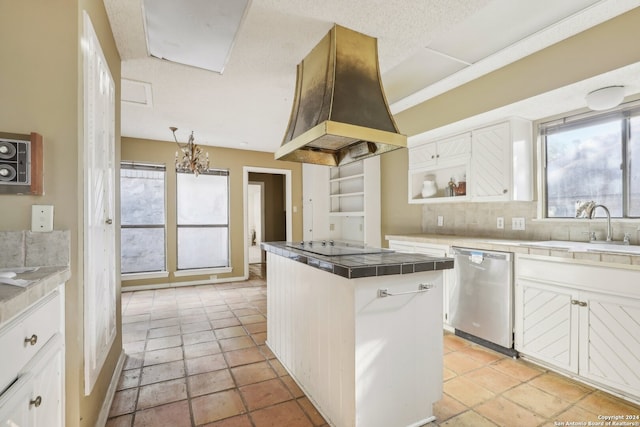 kitchen with white cabinets, custom exhaust hood, a kitchen island, stainless steel dishwasher, and tile counters