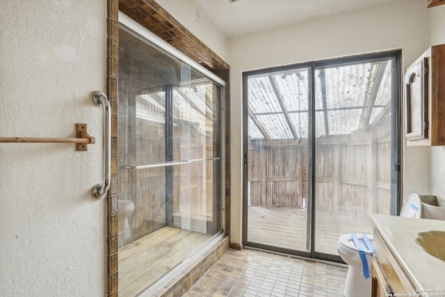 bathroom featuring vanity, a shower with shower door, toilet, and tile patterned flooring