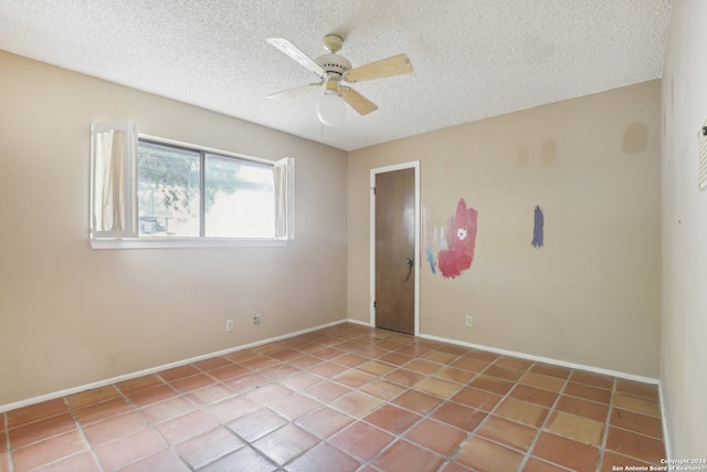 interior space with ceiling fan, light tile patterned floors, and a textured ceiling