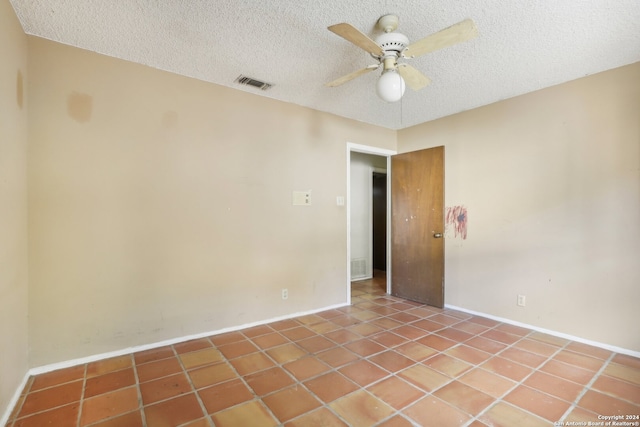 unfurnished room featuring tile patterned flooring, ceiling fan, and a textured ceiling