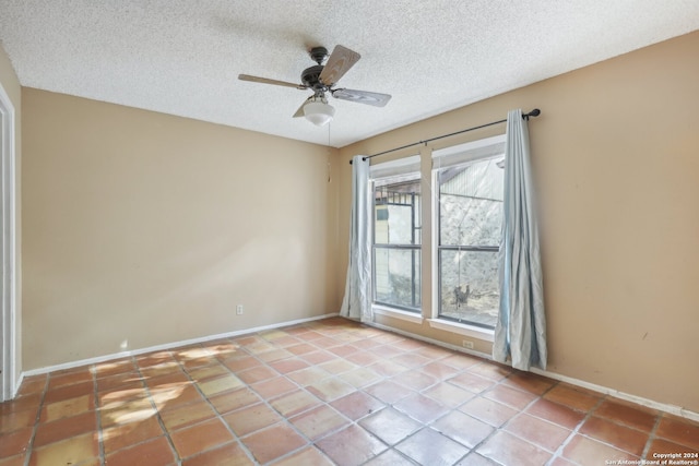 unfurnished room with a textured ceiling, light tile patterned floors, ceiling fan, and plenty of natural light