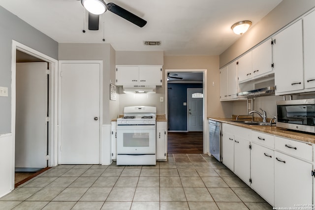 kitchen with sink, white cabinetry, stainless steel appliances, and extractor fan