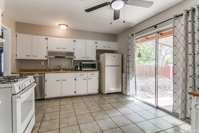 kitchen featuring white cabinetry, light tile patterned floors, appliances with stainless steel finishes, and sink