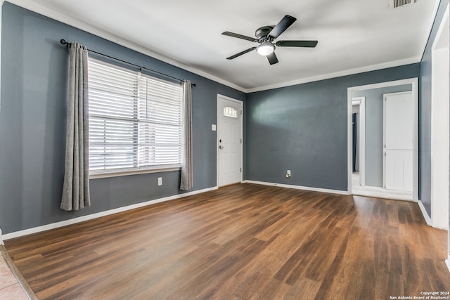 empty room featuring ceiling fan, ornamental molding, and dark hardwood / wood-style flooring