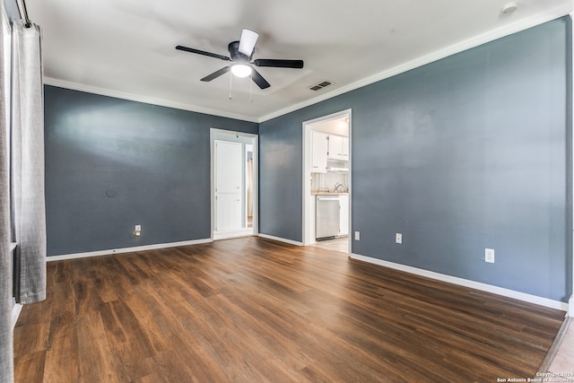 unfurnished bedroom featuring ensuite bathroom, ornamental molding, dark hardwood / wood-style flooring, and ceiling fan