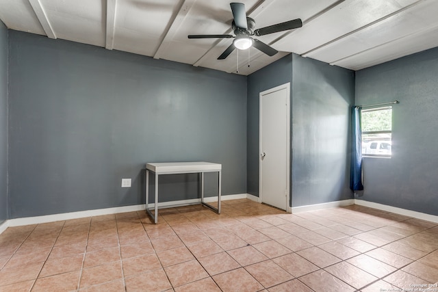 spare room featuring ceiling fan and light tile patterned floors