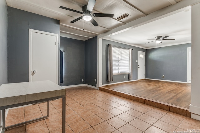 unfurnished room featuring light hardwood / wood-style floors, crown molding, and ceiling fan