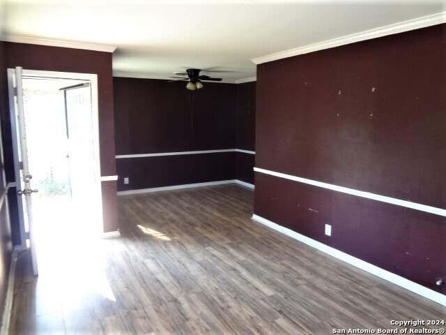 unfurnished room with ornamental molding, dark hardwood / wood-style flooring, and ceiling fan