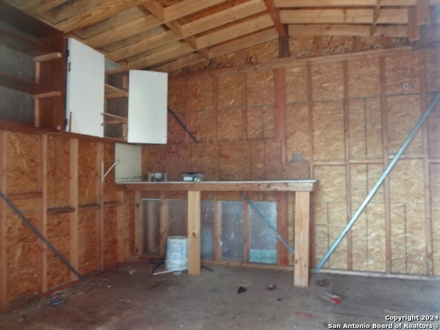 miscellaneous room with lofted ceiling