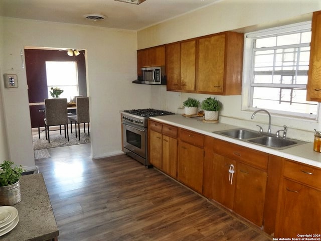 kitchen with sink, appliances with stainless steel finishes, and dark wood-type flooring