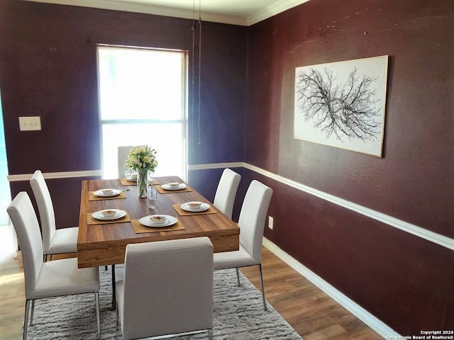 dining space featuring crown molding and hardwood / wood-style floors