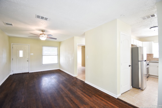 interior space featuring light hardwood / wood-style floors, a textured ceiling, and ceiling fan