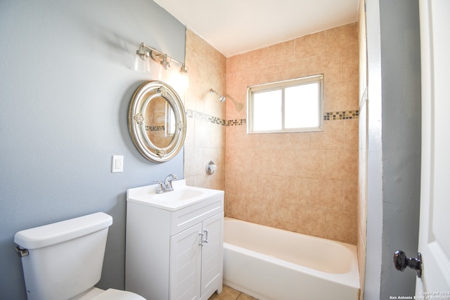 full bathroom with tiled shower / bath, vanity, and toilet