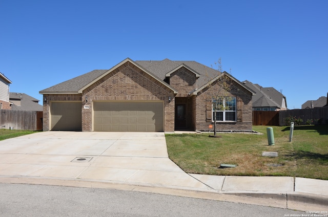 view of front of home featuring a garage and a front lawn