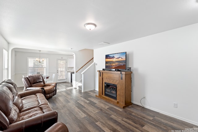 living room with an inviting chandelier and dark hardwood / wood-style floors