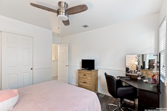 bedroom featuring ceiling fan, a closet, and dark wood-type flooring