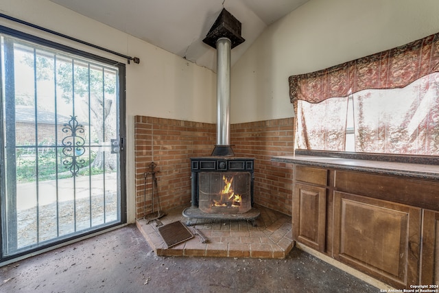 details with concrete flooring and a wood stove