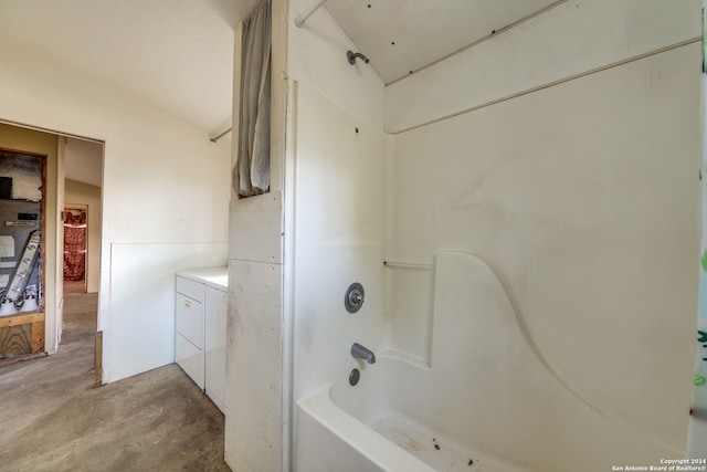 bathroom with shower / bathing tub combination, vanity, washer / clothes dryer, and concrete floors