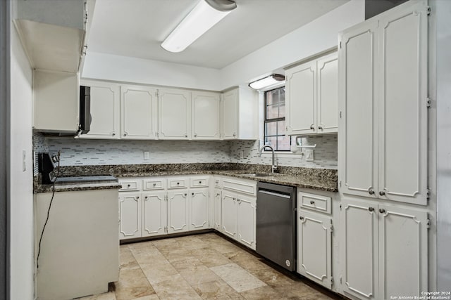 kitchen with appliances with stainless steel finishes, backsplash, white cabinetry, and sink