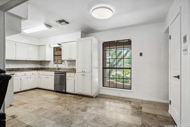 kitchen with white cabinetry, dishwasher, and backsplash