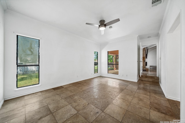 spare room with ornamental molding and ceiling fan