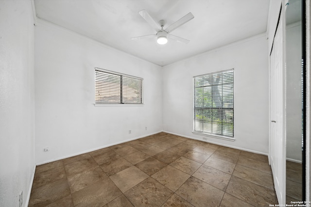 unfurnished room with ornamental molding and ceiling fan