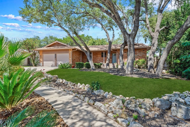 ranch-style house featuring a garage and a front yard