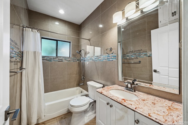 full bathroom with tile walls, vanity, shower / bath combination with curtain, toilet, and tile patterned floors