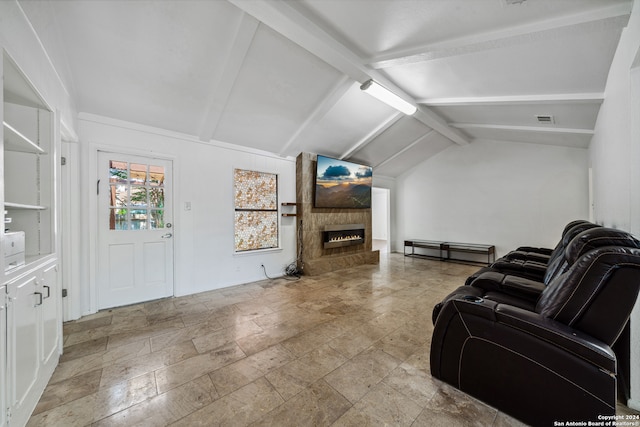 living room with a large fireplace and vaulted ceiling with beams