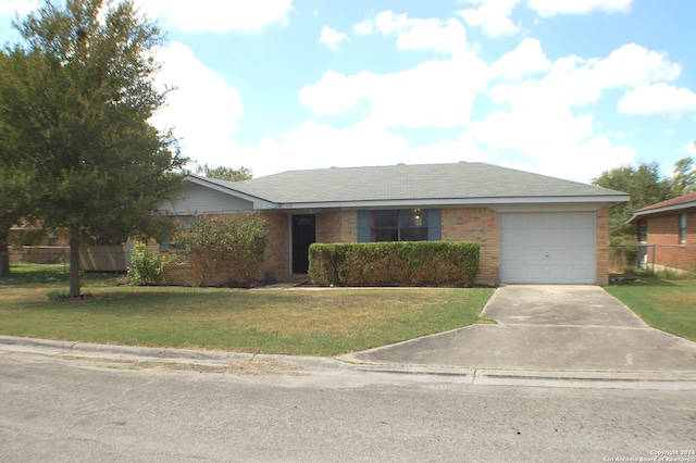 ranch-style home with a front lawn and a garage