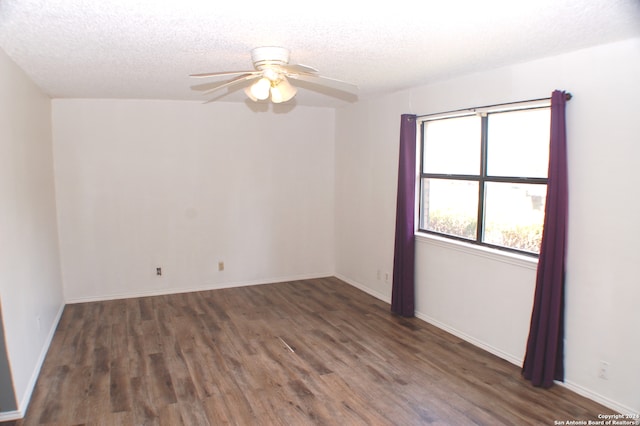 unfurnished room with ceiling fan, dark wood-type flooring, and a textured ceiling