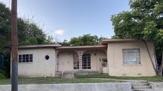 view of front of home featuring brick siding