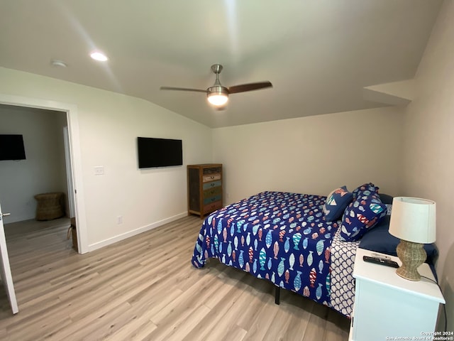 bedroom featuring wood-type flooring, vaulted ceiling, and ceiling fan