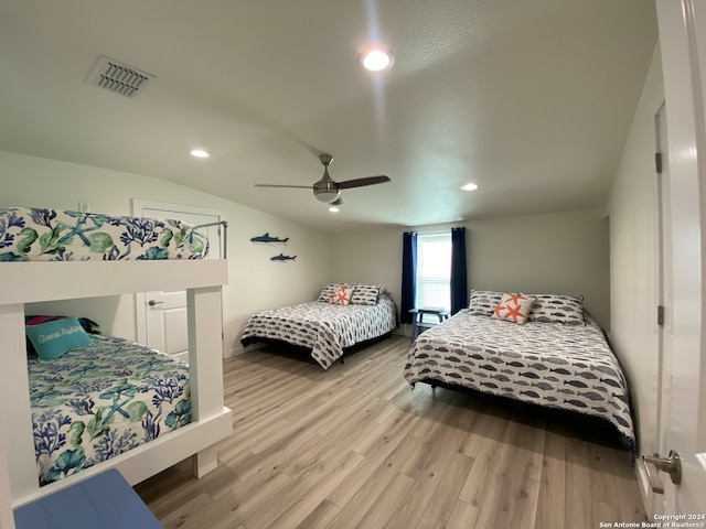 bedroom with wood-type flooring, lofted ceiling, and ceiling fan