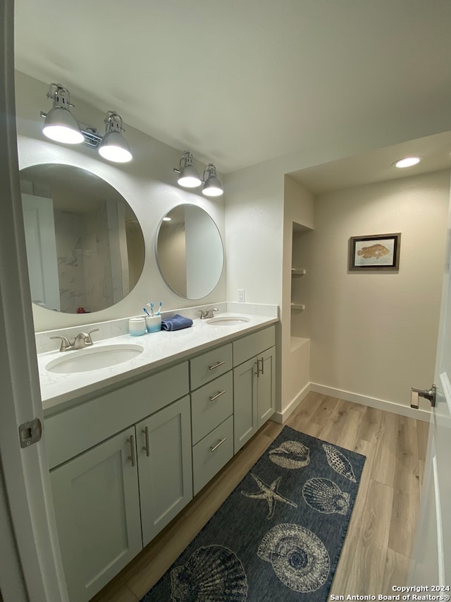 bathroom featuring vanity, a bathtub, and hardwood / wood-style floors