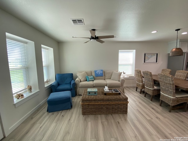 living room featuring light wood-type flooring and ceiling fan