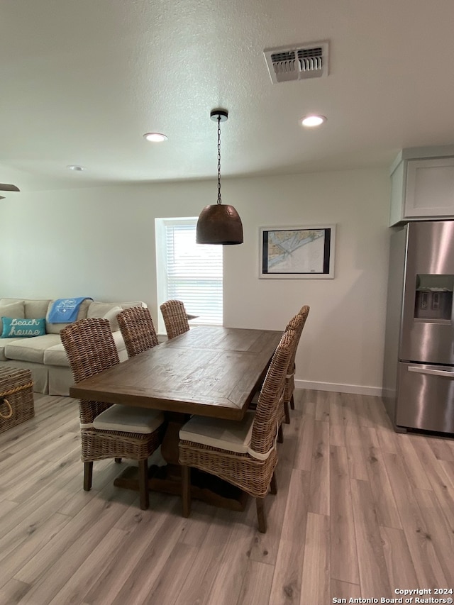 dining area featuring light wood-type flooring