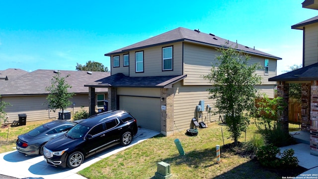 view of front facade with a front yard and a garage